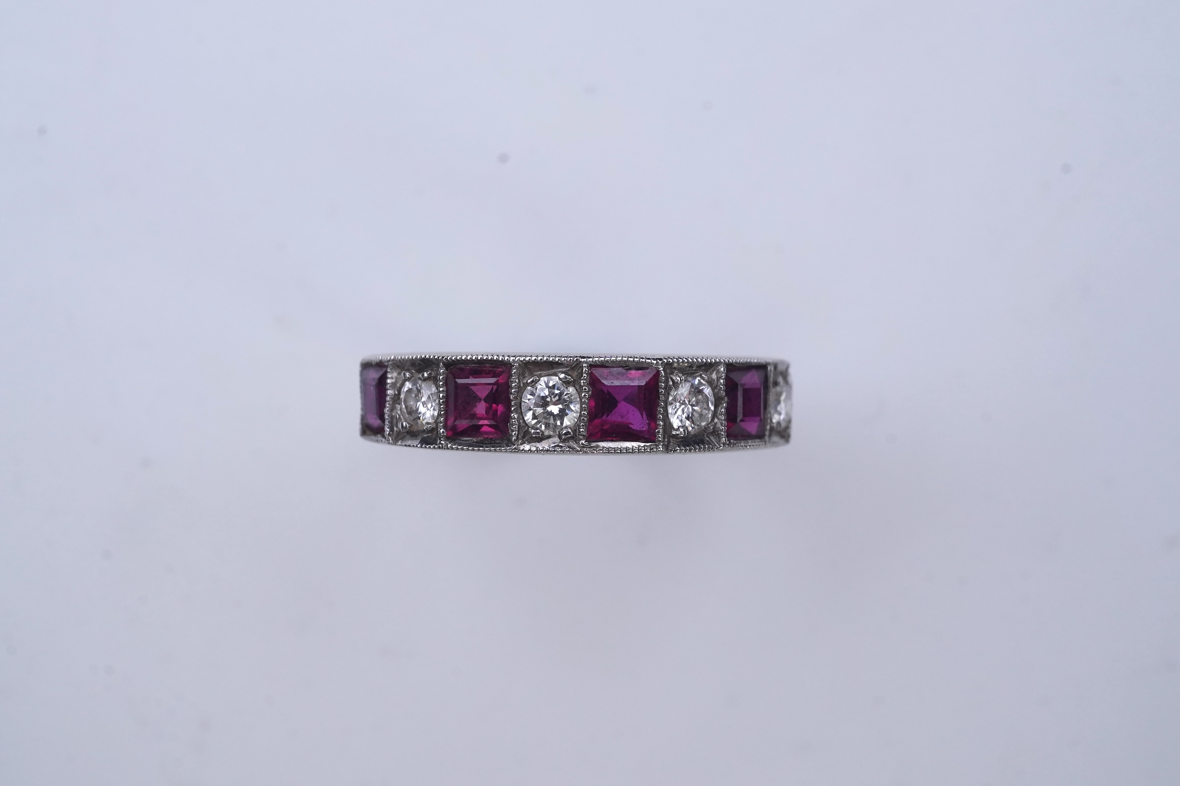 A ruby and diamond half eternity ring